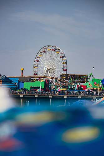amusement park selective focus photography of people near ferris wheel san diego